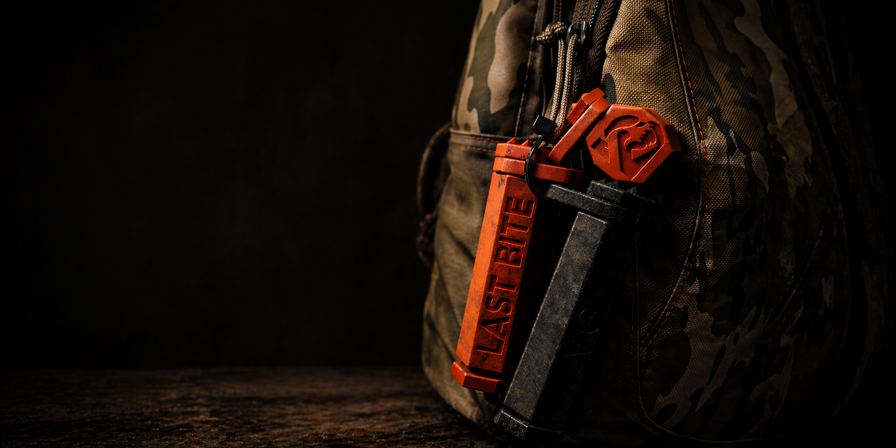 A Last Bite Pro jaw tool clipped onto a hunting pack strap, hanging ready for use.
